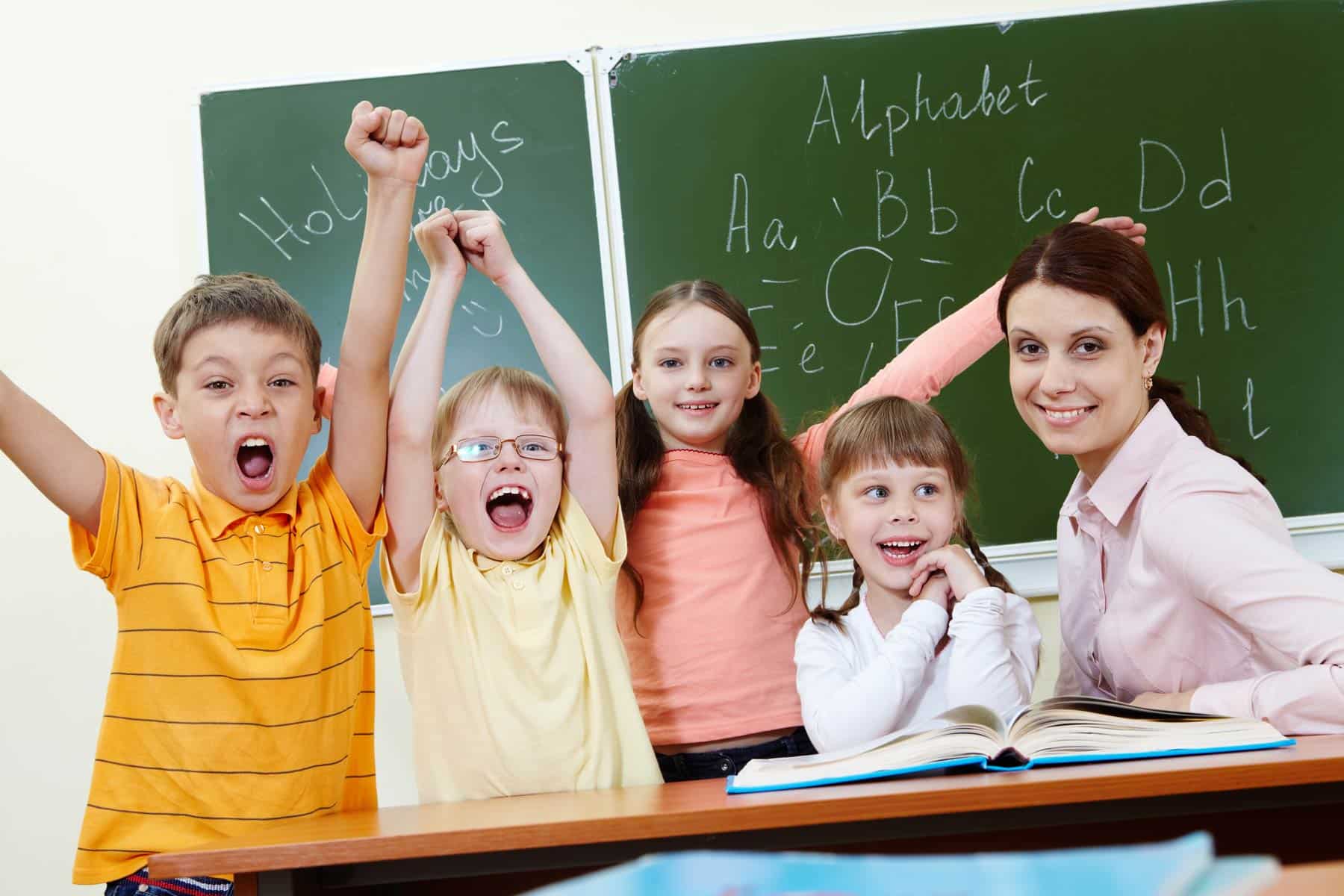 Children cheering in the classroom and excited to learn
