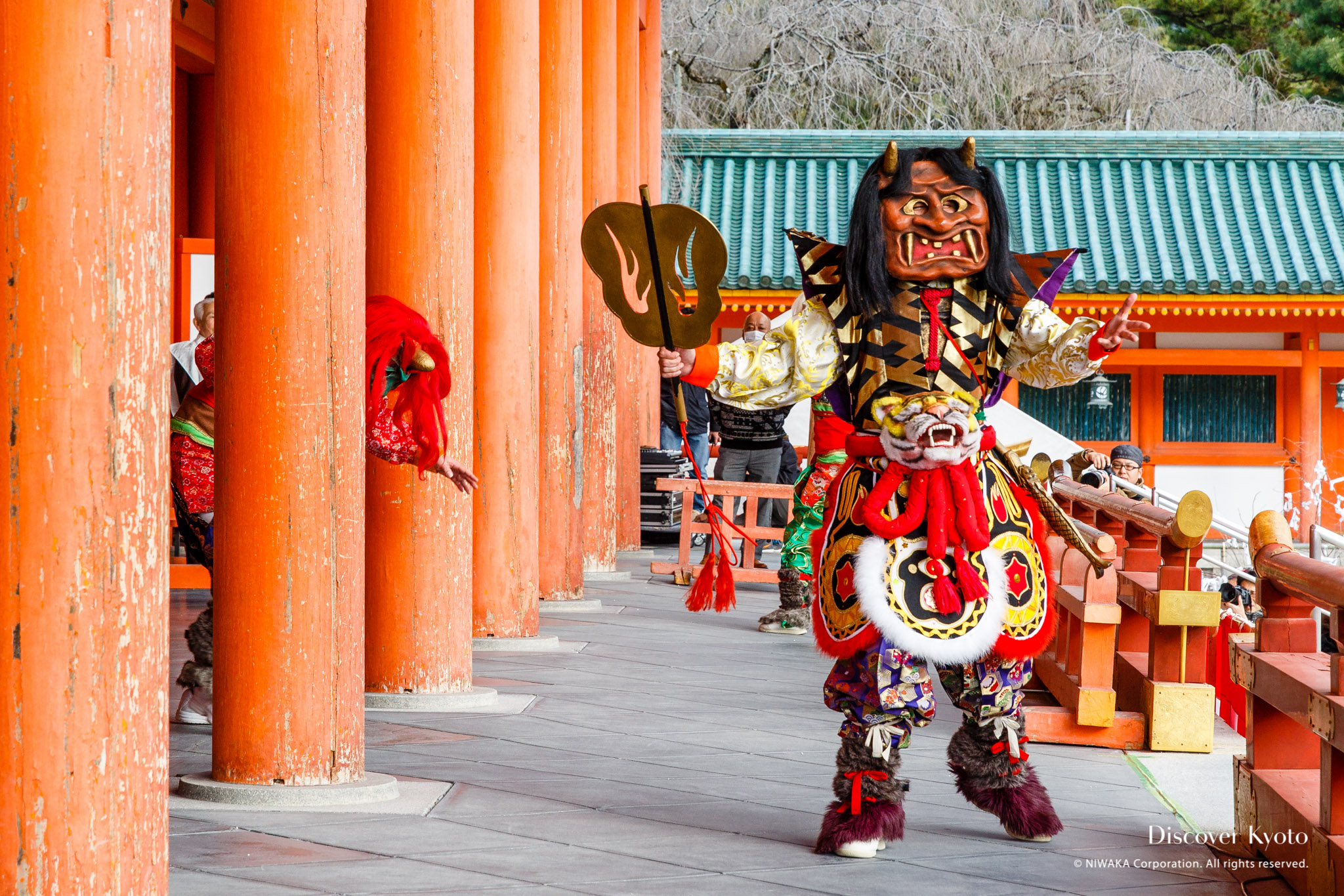 man in an ogre mask at a shrine